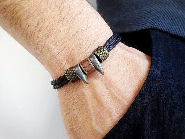 BIKER BRACELET STYLE ON VEGAN BLACK LEATHER WITH LARGE SILVER LOBSTER CLASP 2 SPIKED BEADS 2 BRONZE COLOR AND ONE COPPER COLOR WORN ON A WRIST
