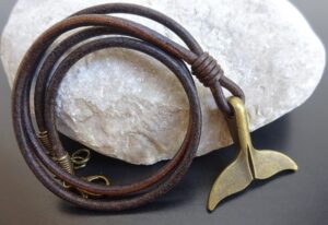 bronze whale tail pendant on leather