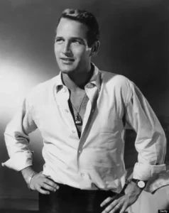 PAUL NEWMAN WITH UNTACKED SHIRT SHOWING NECKLACES