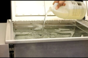 homemdae ultrasonic cleaning solution poured in the cleaning machine